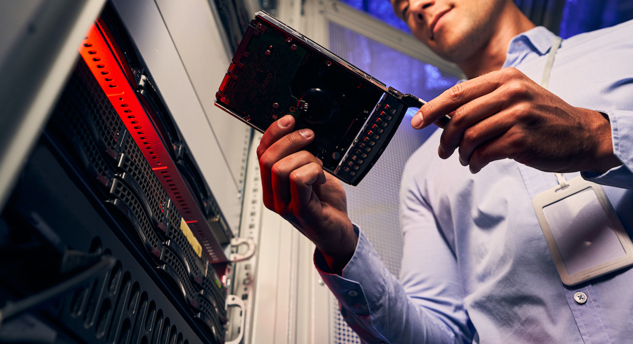 Data center technician maintaining server infrastructure for reliable operations